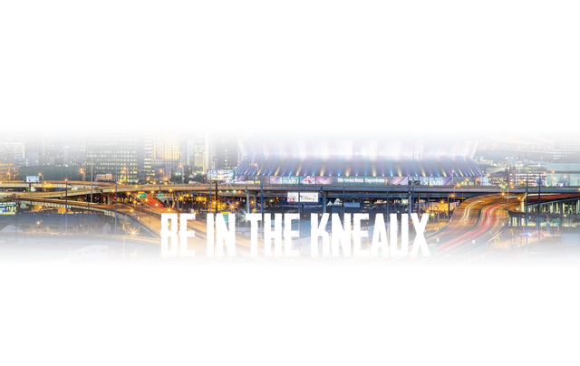 A picture of a city at night with the words `` be in the kneaux '' written on it.