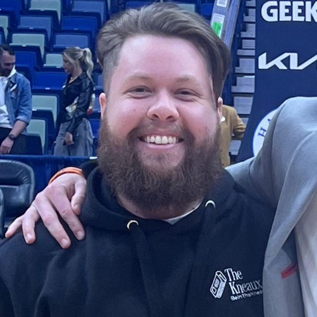 A man with a beard wearing a black hoodie with the word geek on it