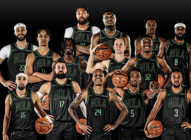 A group of basketball players are posing for a team photo.