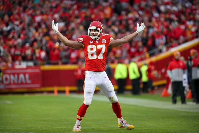 A football player with the number 87 on his jersey is standing on the field.