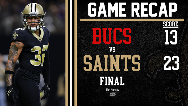 A football player is standing next to a scoreboard that says game recap