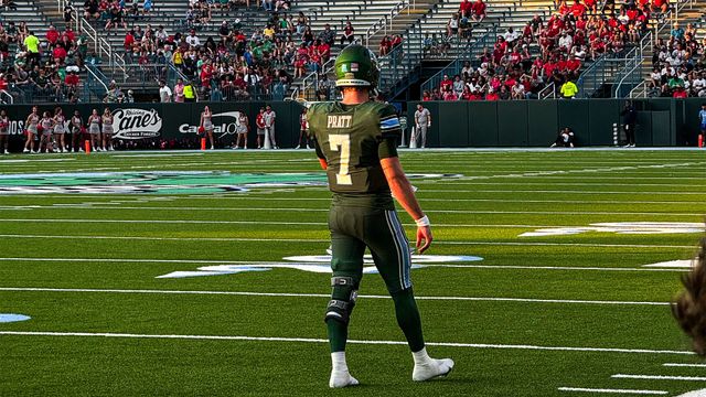 A football player with the number 7 on his jersey is standing on the field.