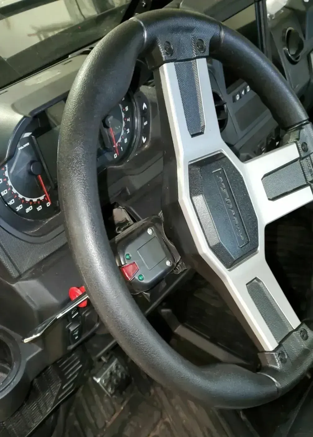 A close up of a steering wheel in a car