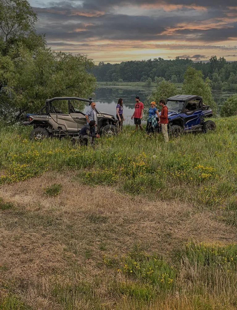 A red atv is driving down a dirt road.