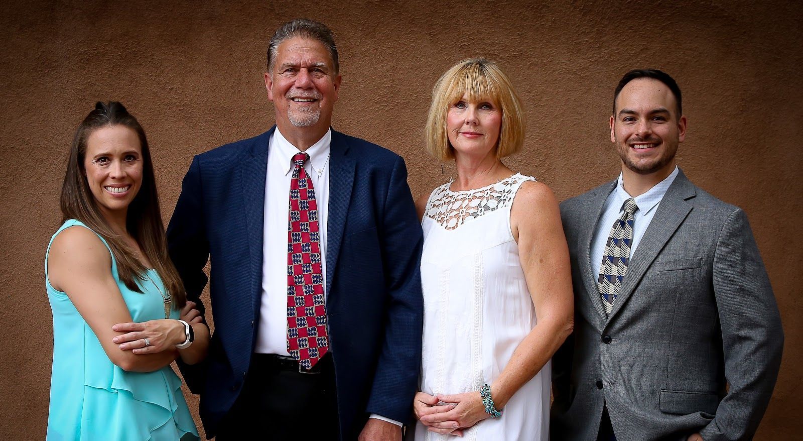 A group of people in suits and ties are posing for a picture.