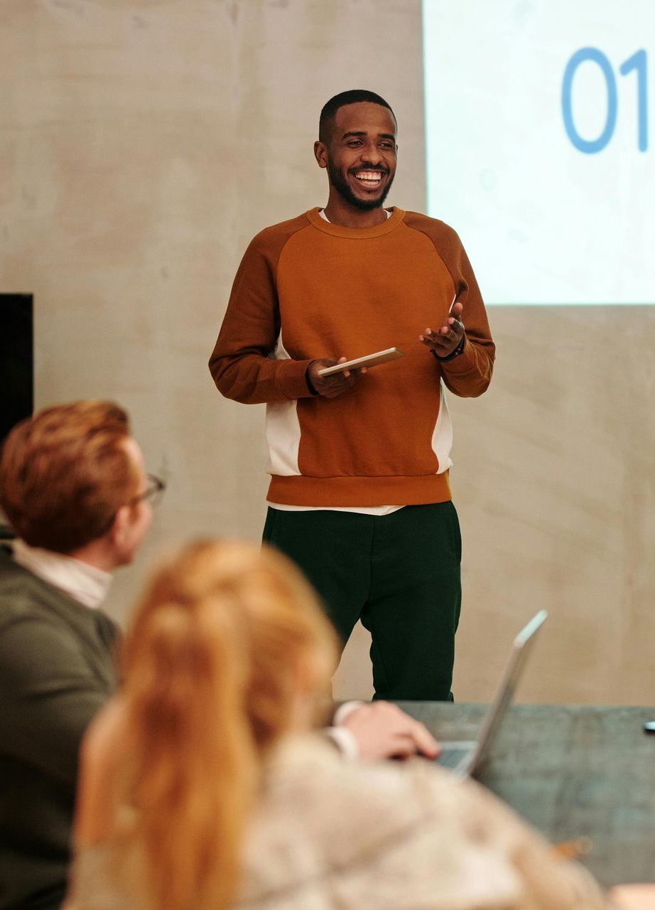 A man is giving a presentation to a group of people.