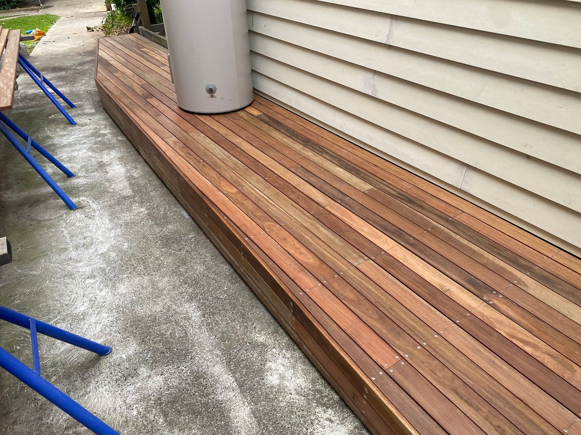 Pool and Patio Area With Blue Water, Wooden Deck and White Walls — Waratah Home Improvements in Coledale, NSW
