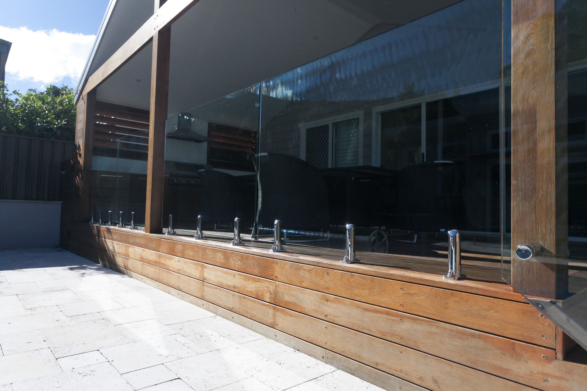 Wooden Deck With Glass Railing, and Attached to a Building, Under a Shaded Patio — Waratah Home Improvements in Coledale, NSW