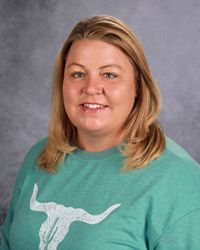 A woman in a black shirt is smiling for the camera.