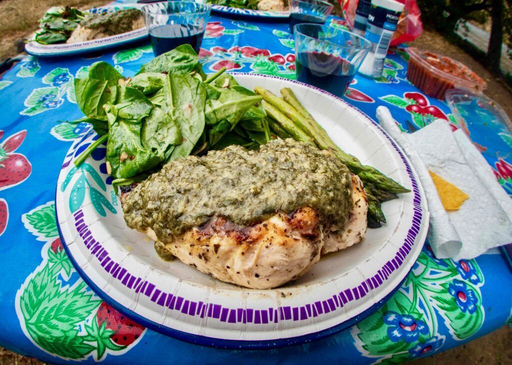 A plate of food with chicken and asparagus on a table.