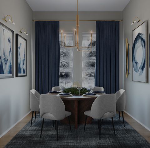 Formal dining room: table set for six, surrounded by gray chairs, blue curtains, artwork, and a gold chandelier.
