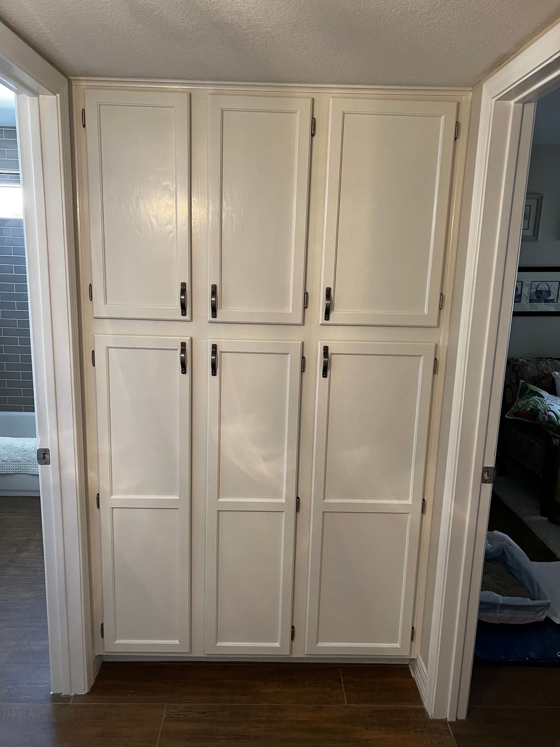 A white cabinet in a room with a door open