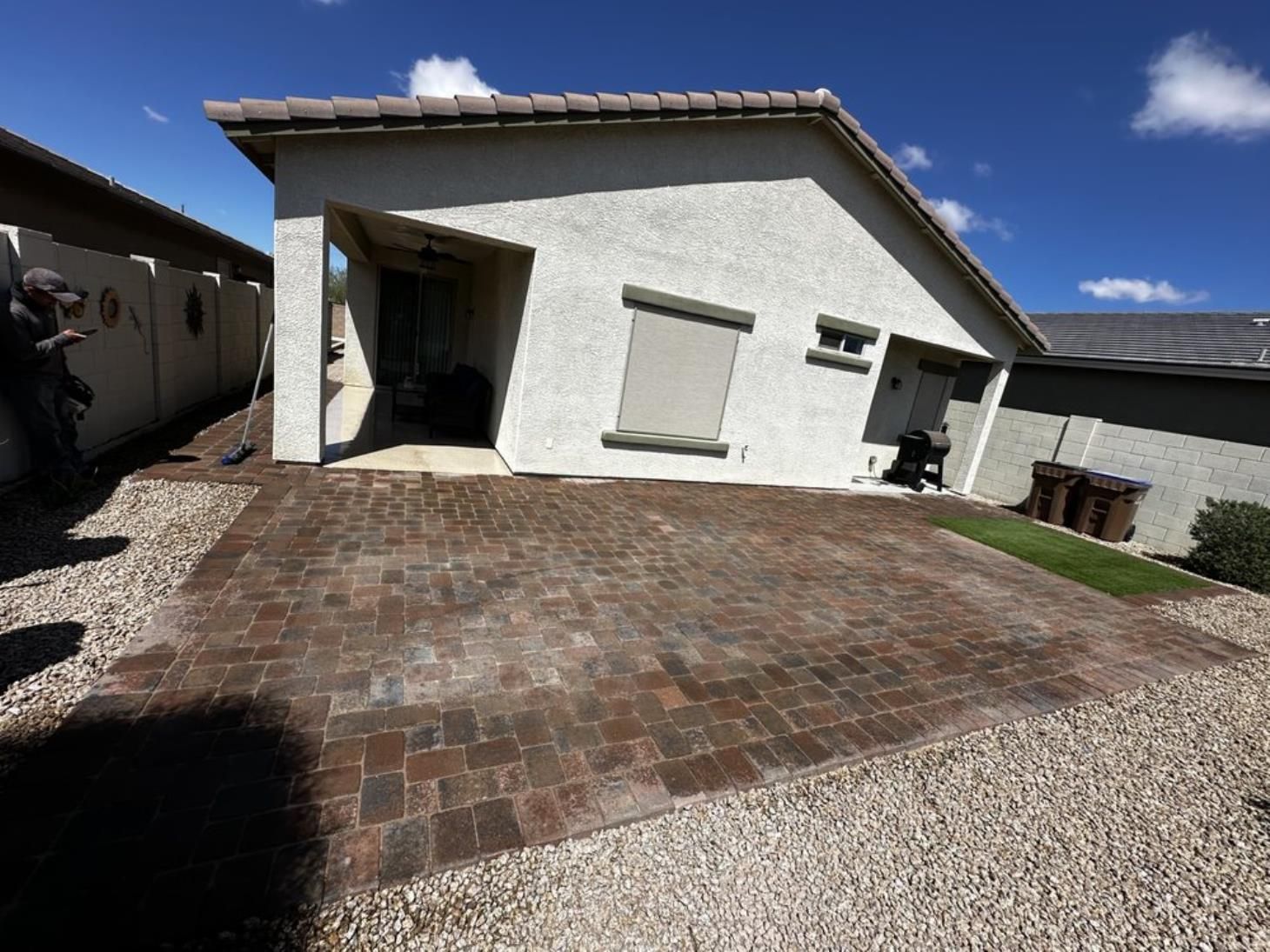 A white house with a brick driveway in front of it