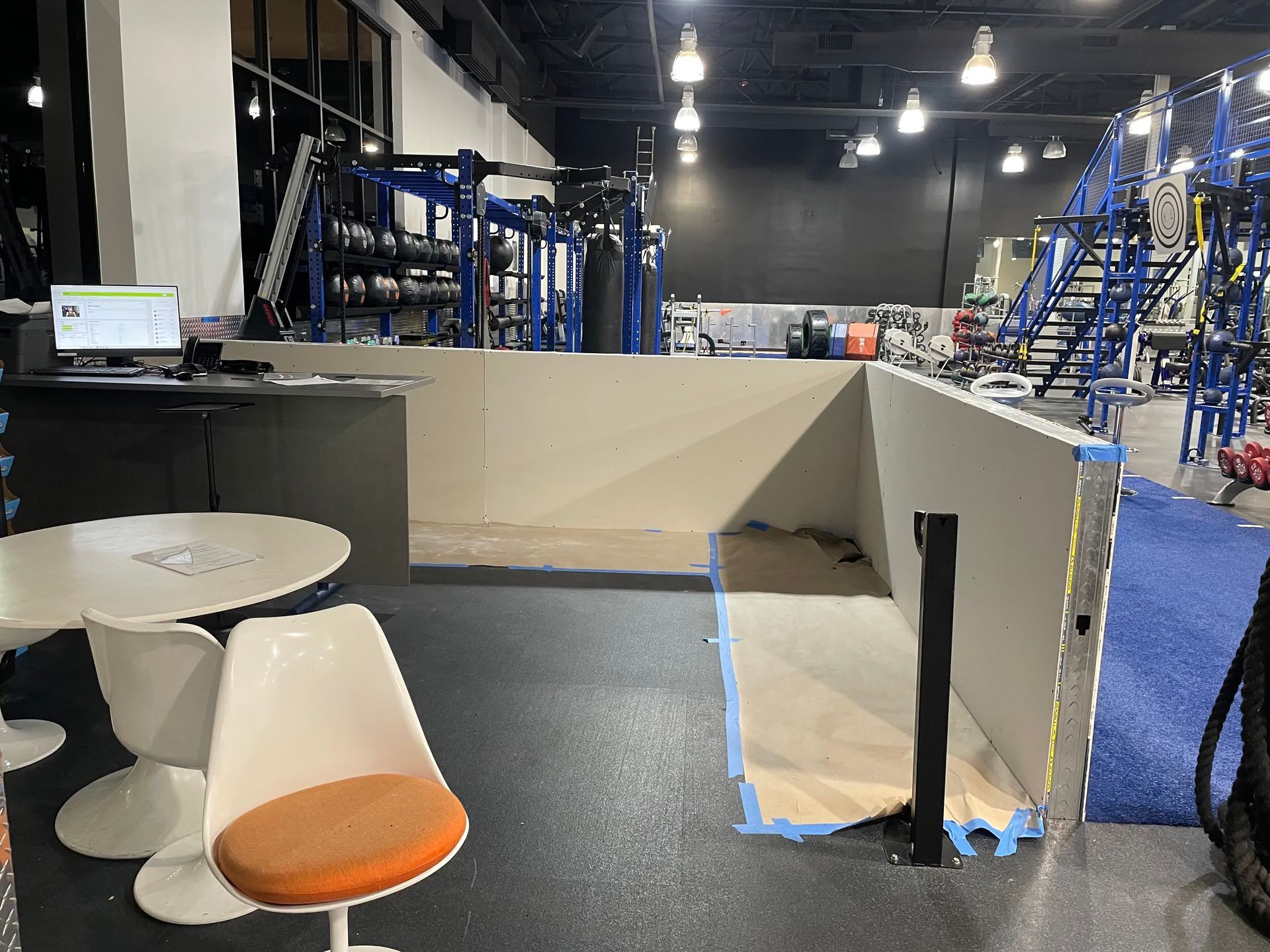 A gym with a table and chairs in it