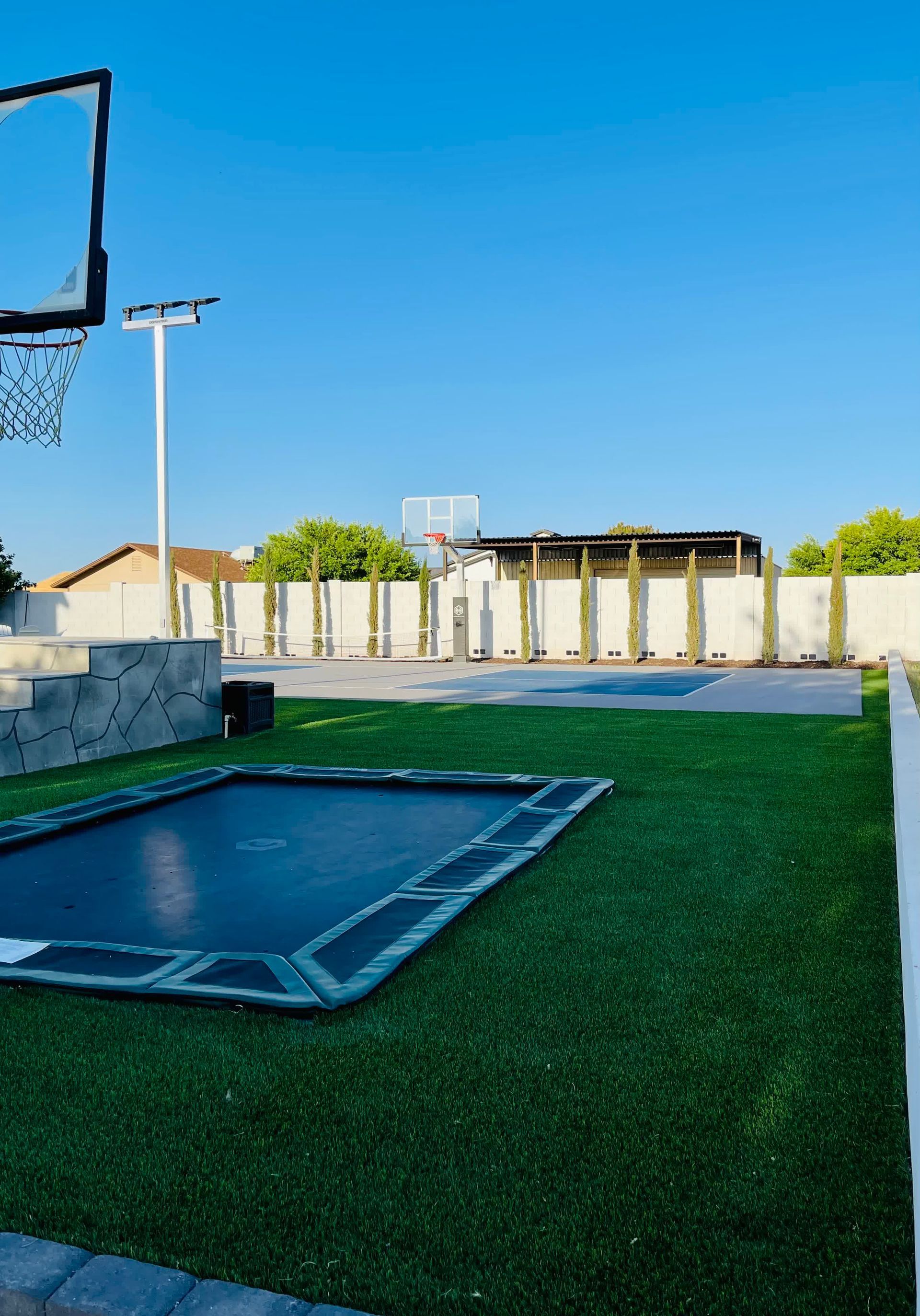 There is a trampoline in the middle of a basketball court.