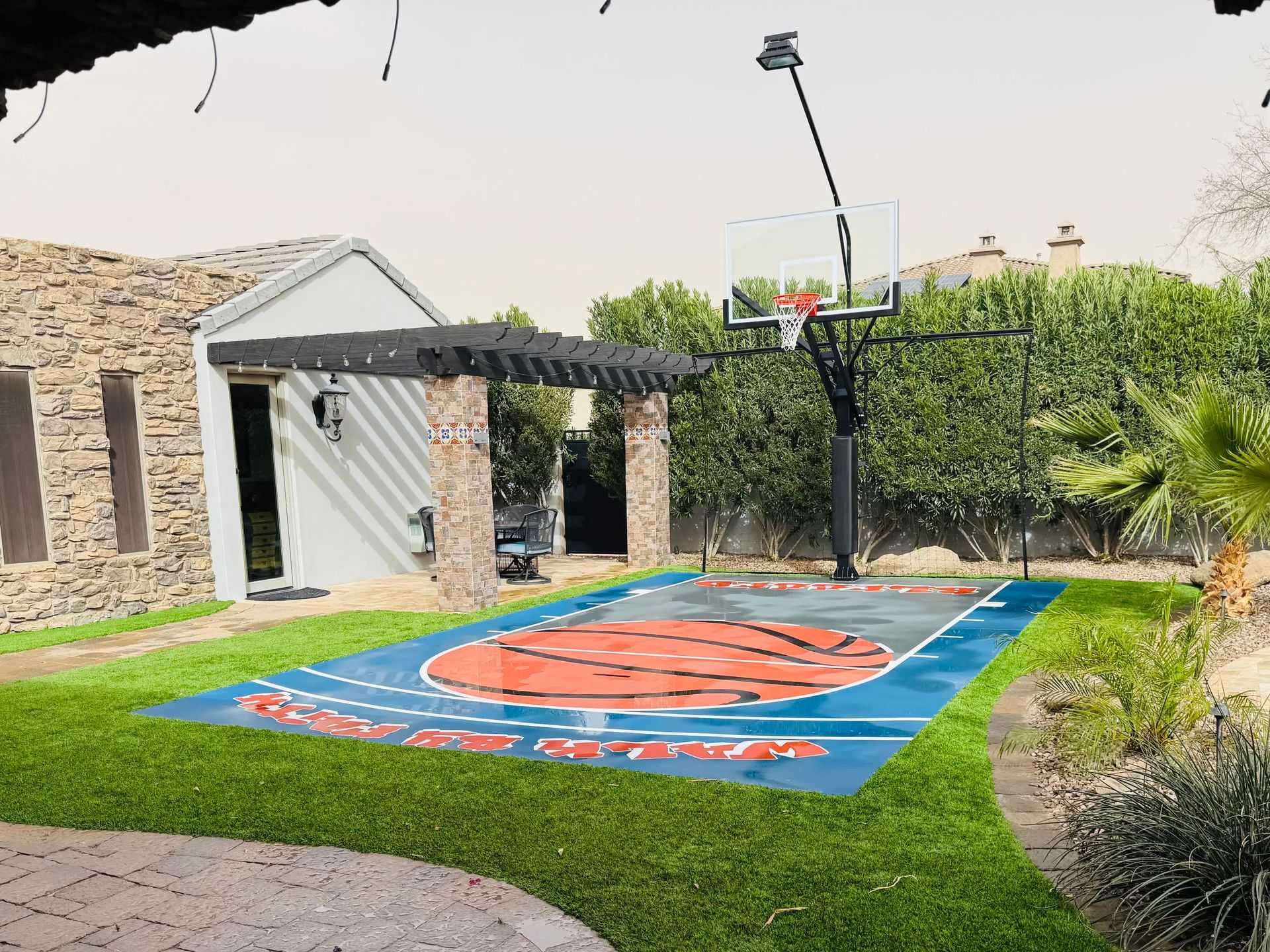 A basketball court in the backyard of a house
