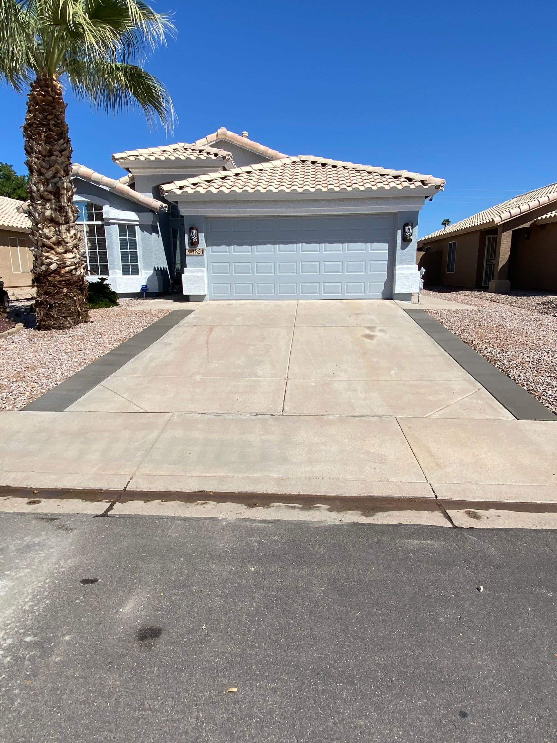 A large house with a palm tree in front of it