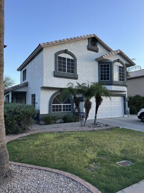 A white house with a palm tree in front of it
