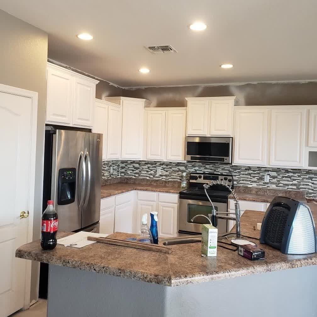 A kitchen with a coca cola bottle on the counter