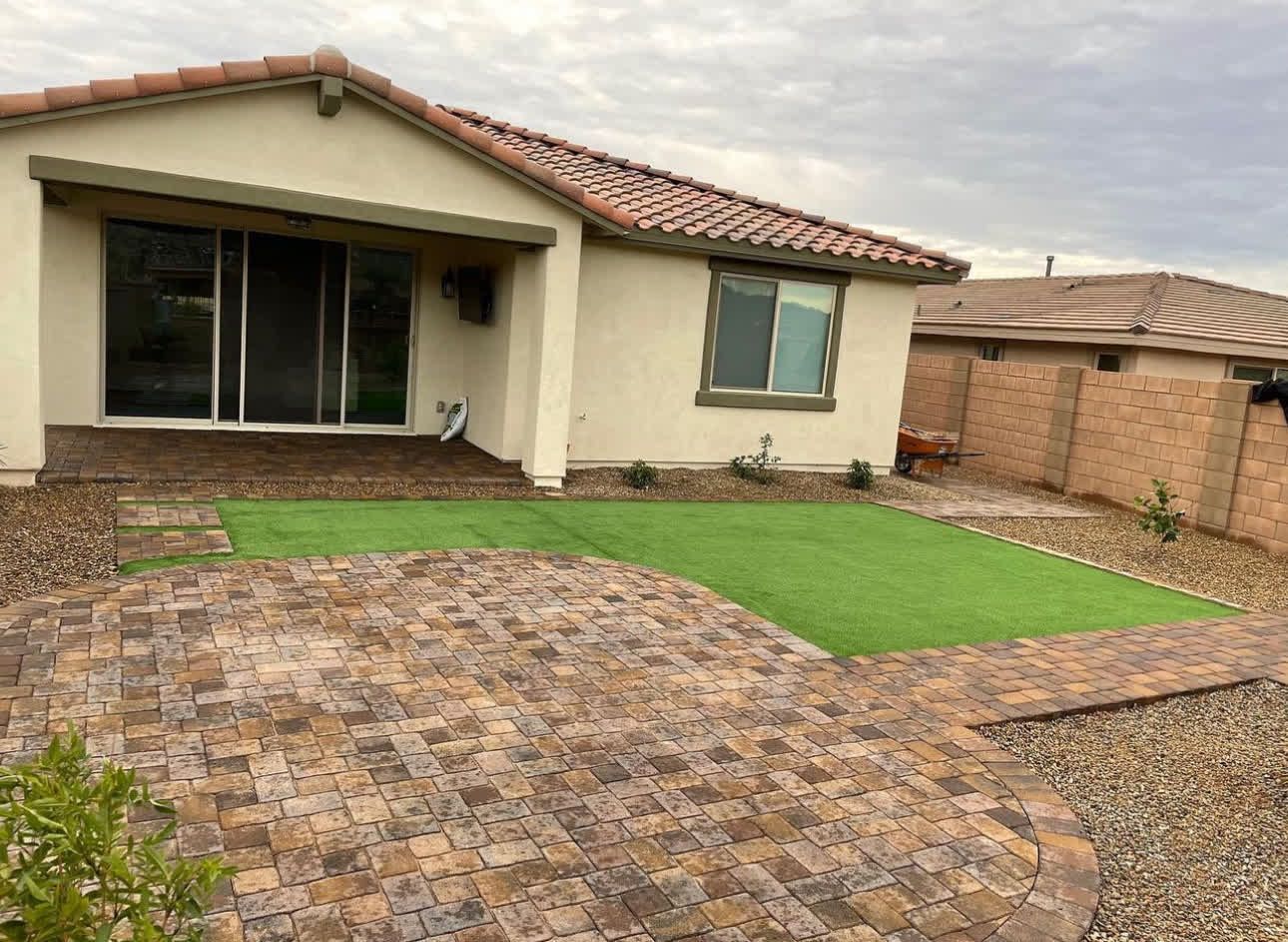 A house with a green lawn in front of it.