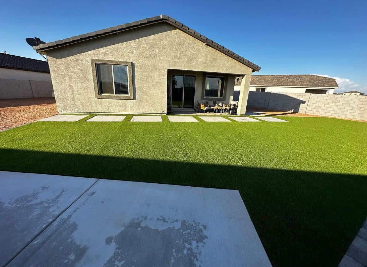 A small house with a large lawn in front of it