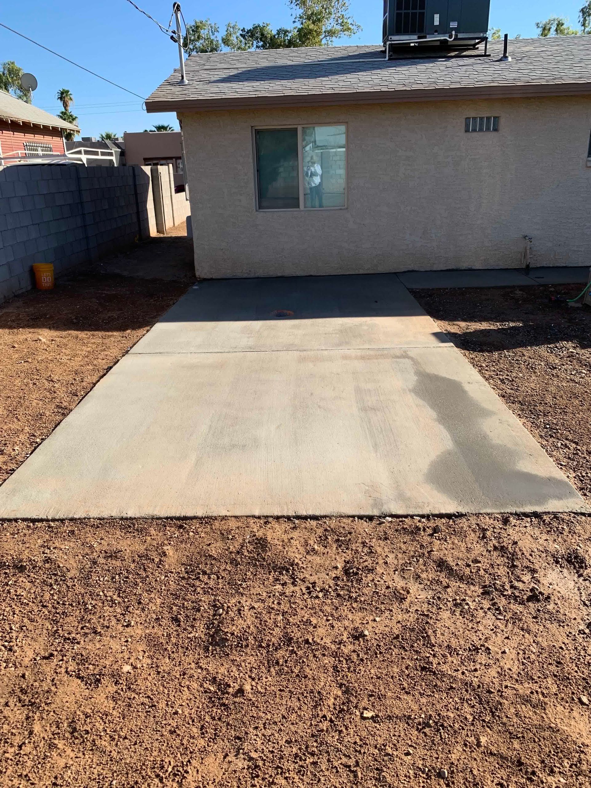 A concrete driveway in front of a house that says loft