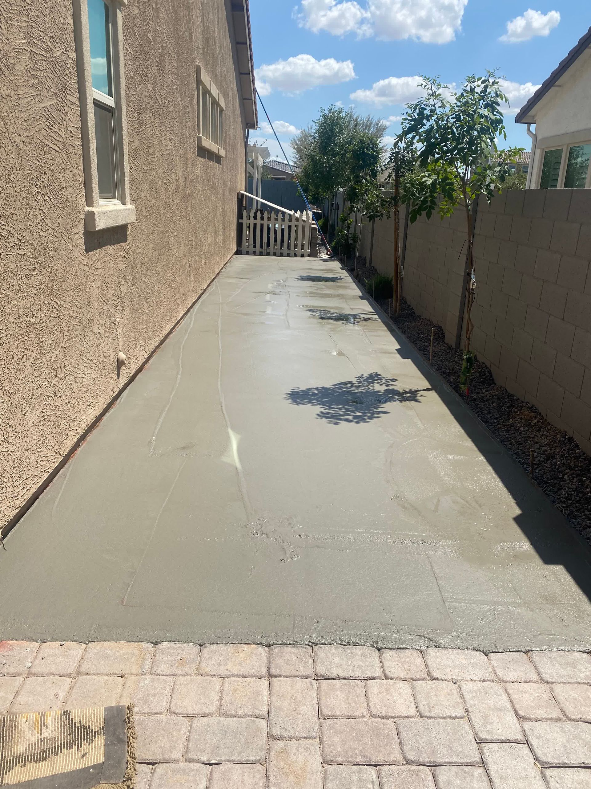 A concrete driveway is being built in front of a house.