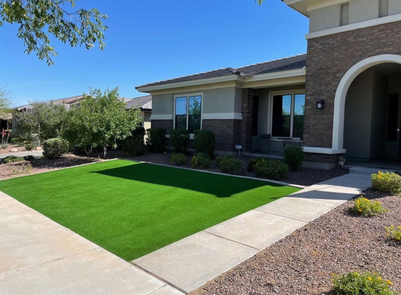 A house with a large lawn in front of it.