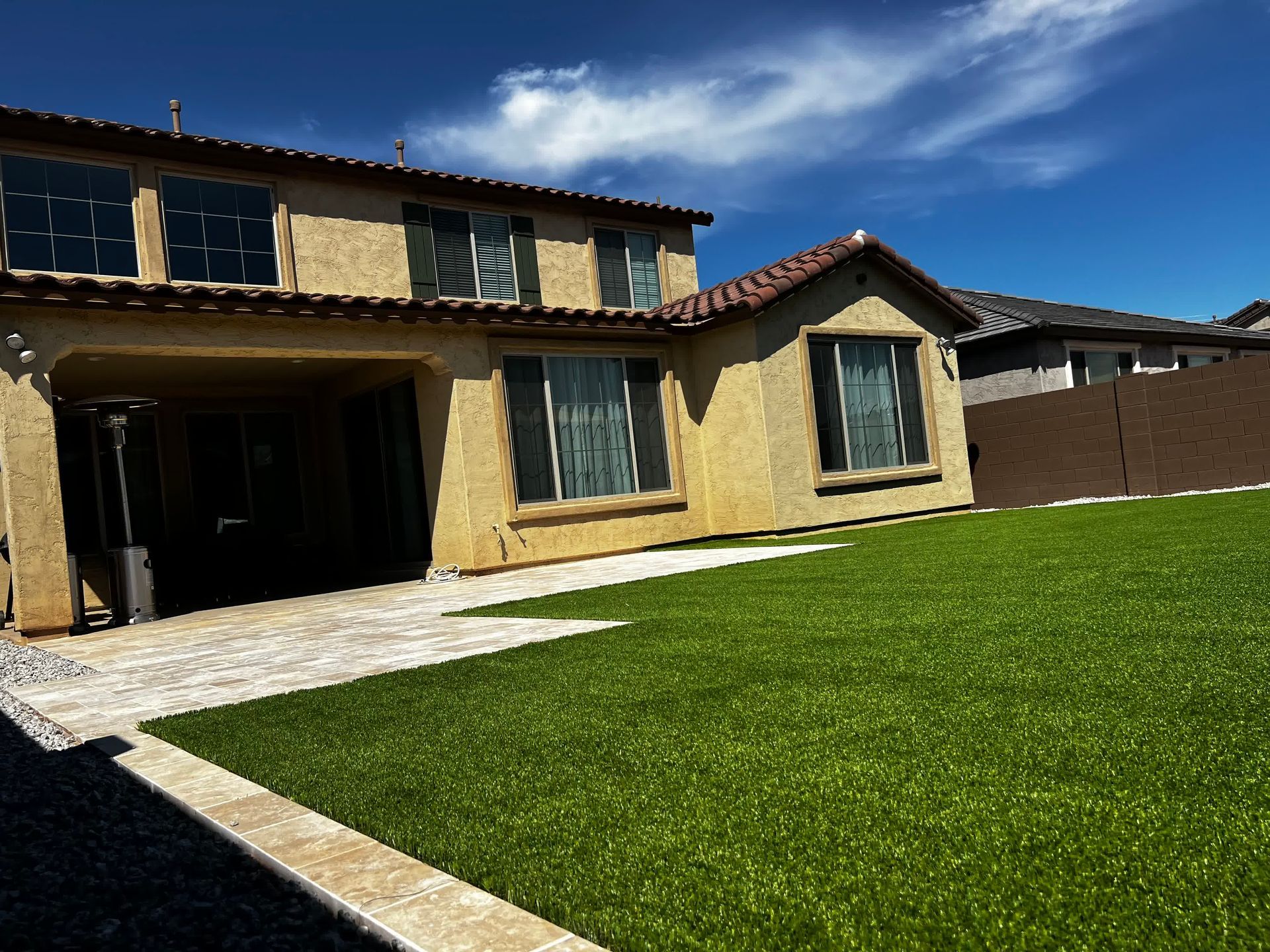 A house with a large lawn in front of it
