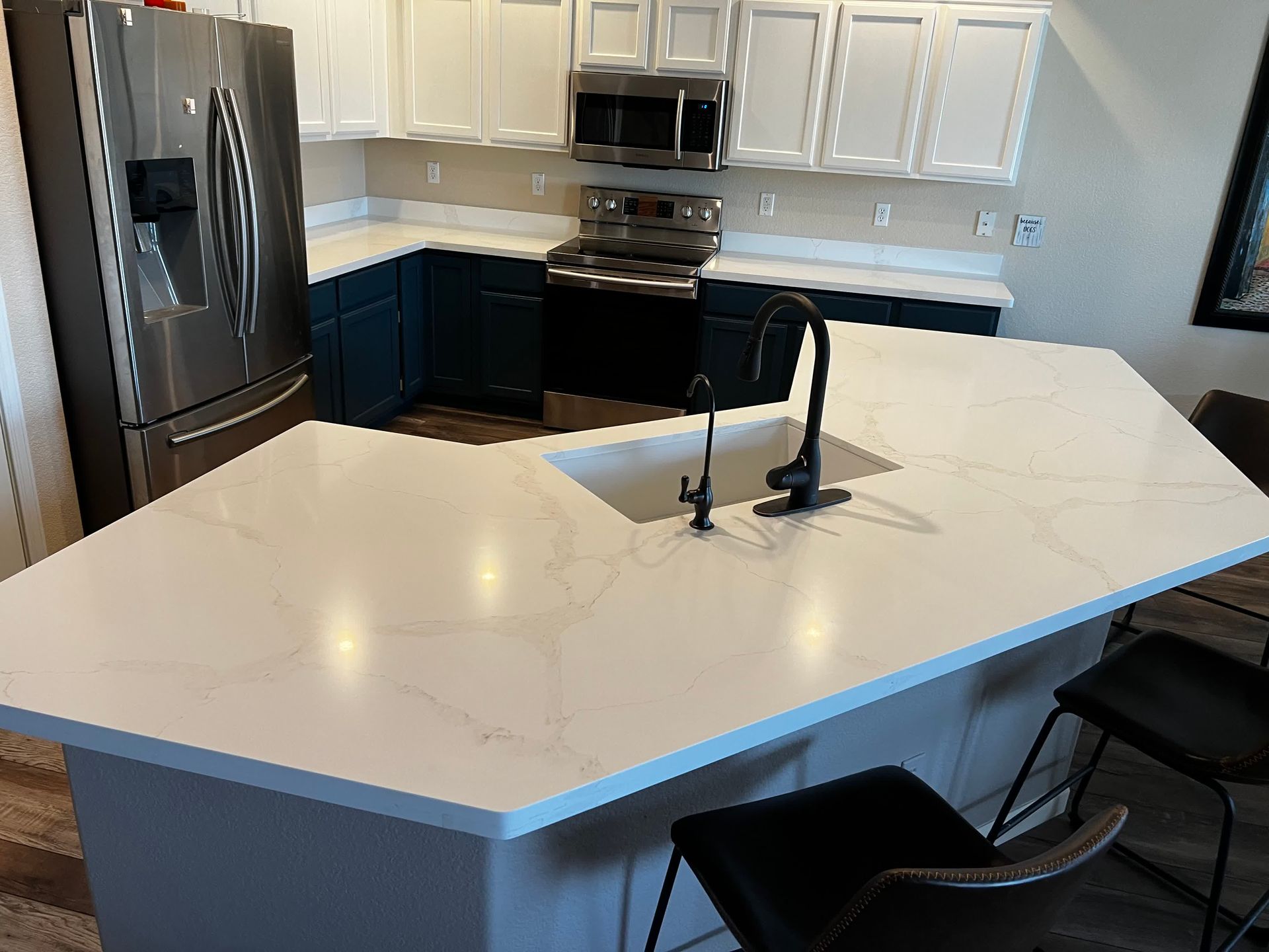 A kitchen with a large island and a sink.