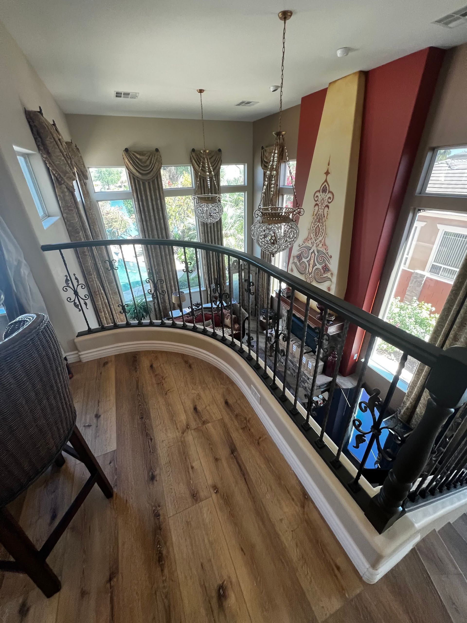 A view of a living room from the second floor of a house.