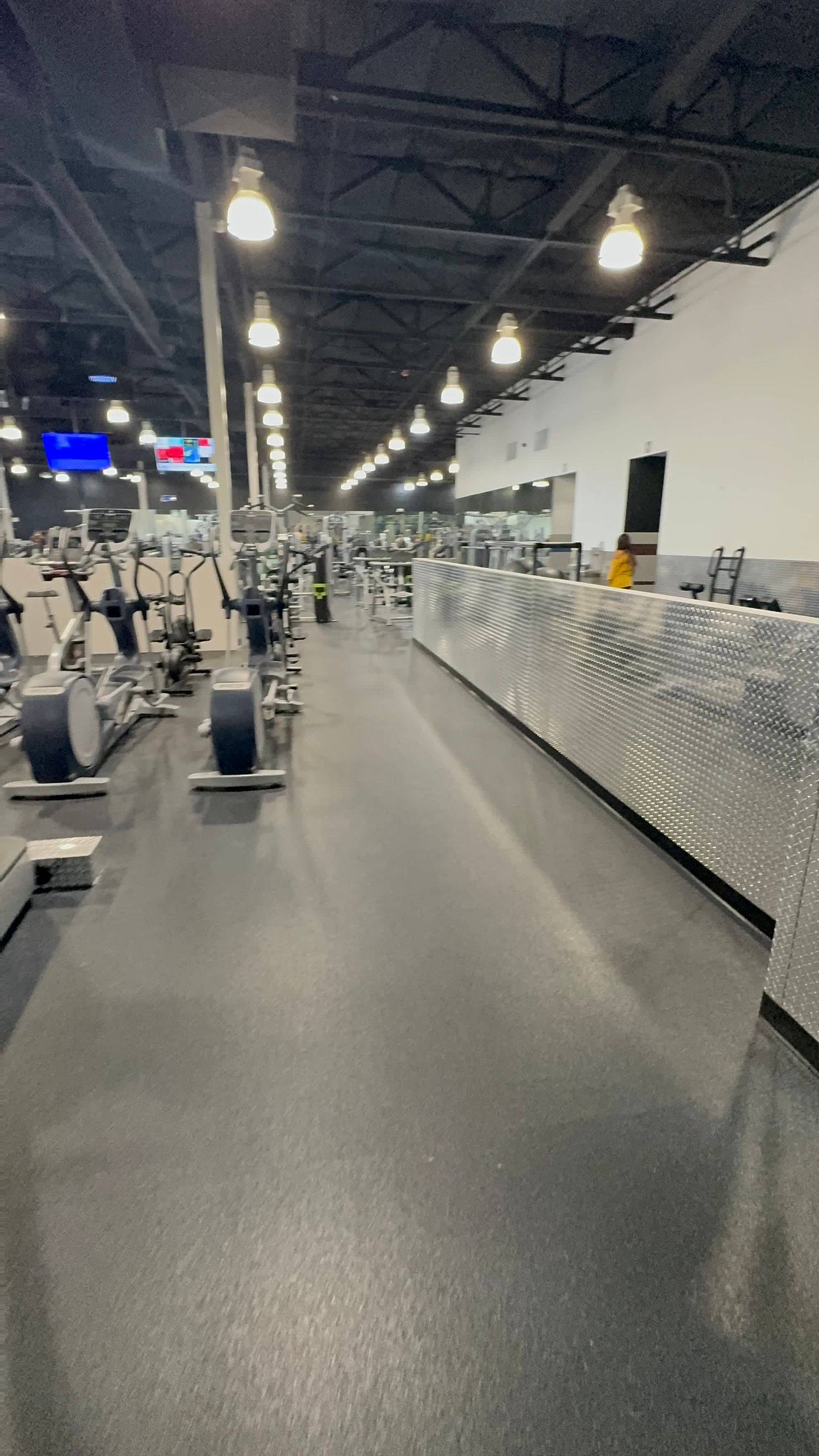 A gym filled with lots of exercise equipment and a counter.