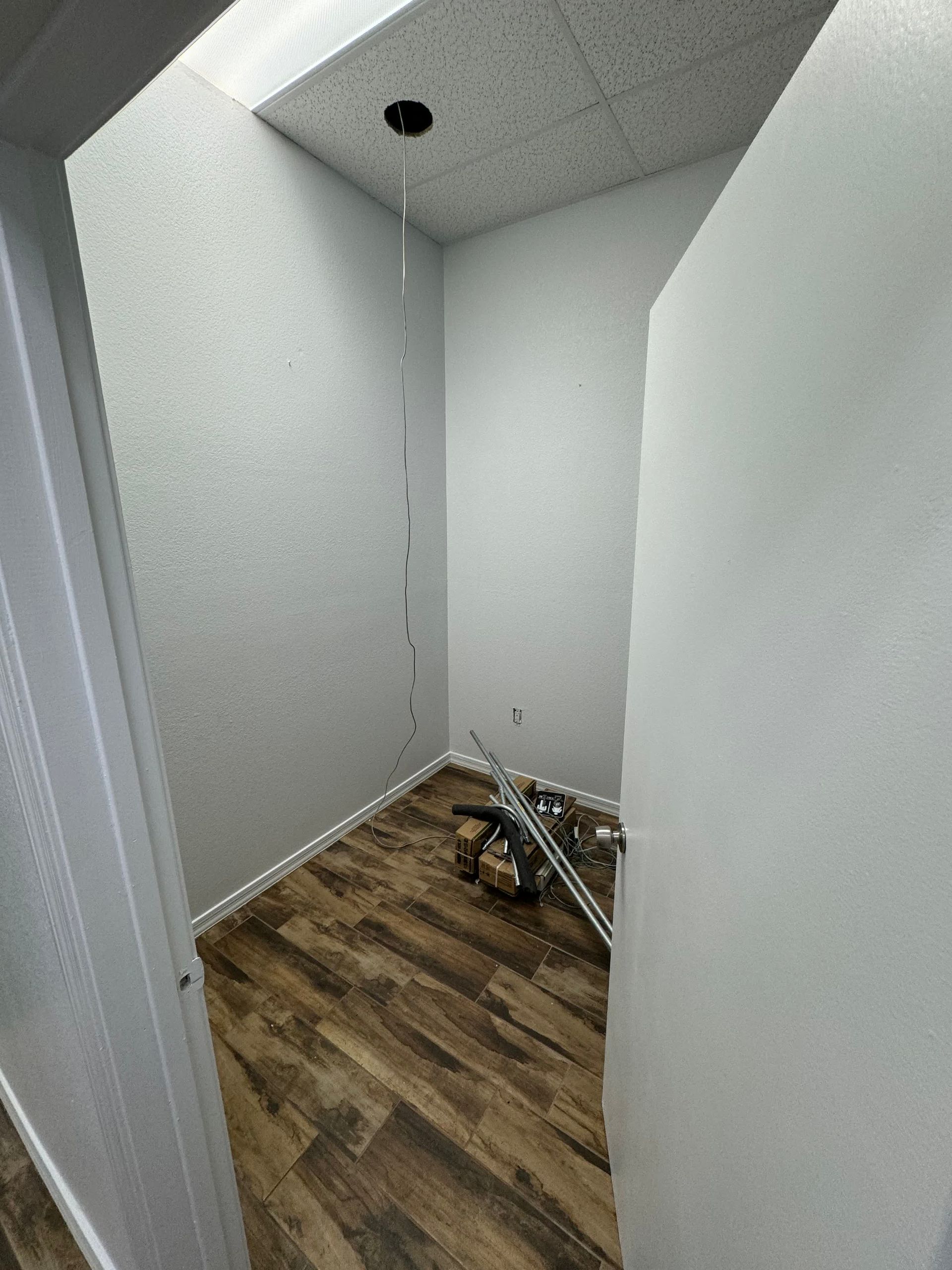 A small room with a wooden floor and white walls.