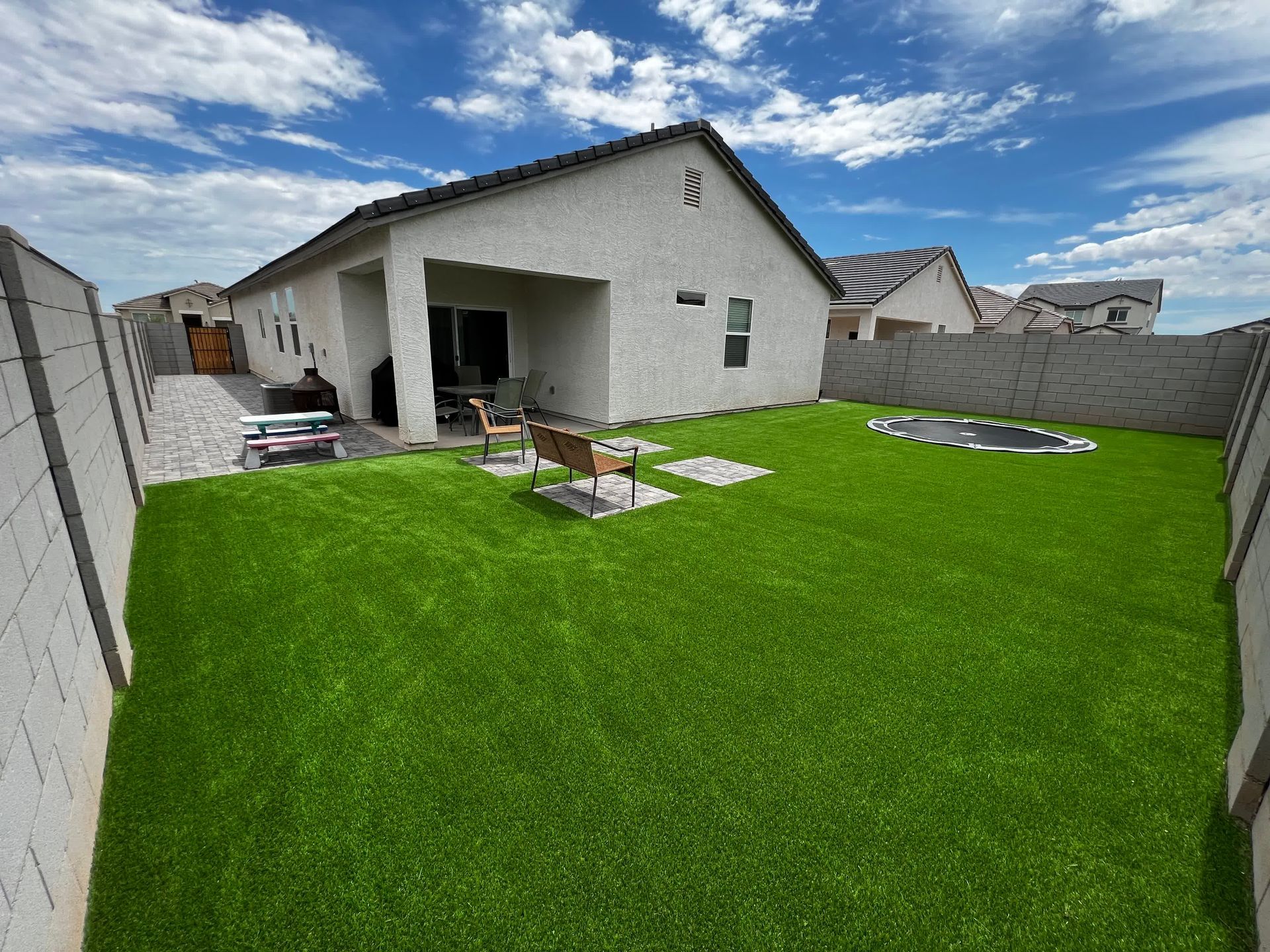 A white house with a large lawn in front of it