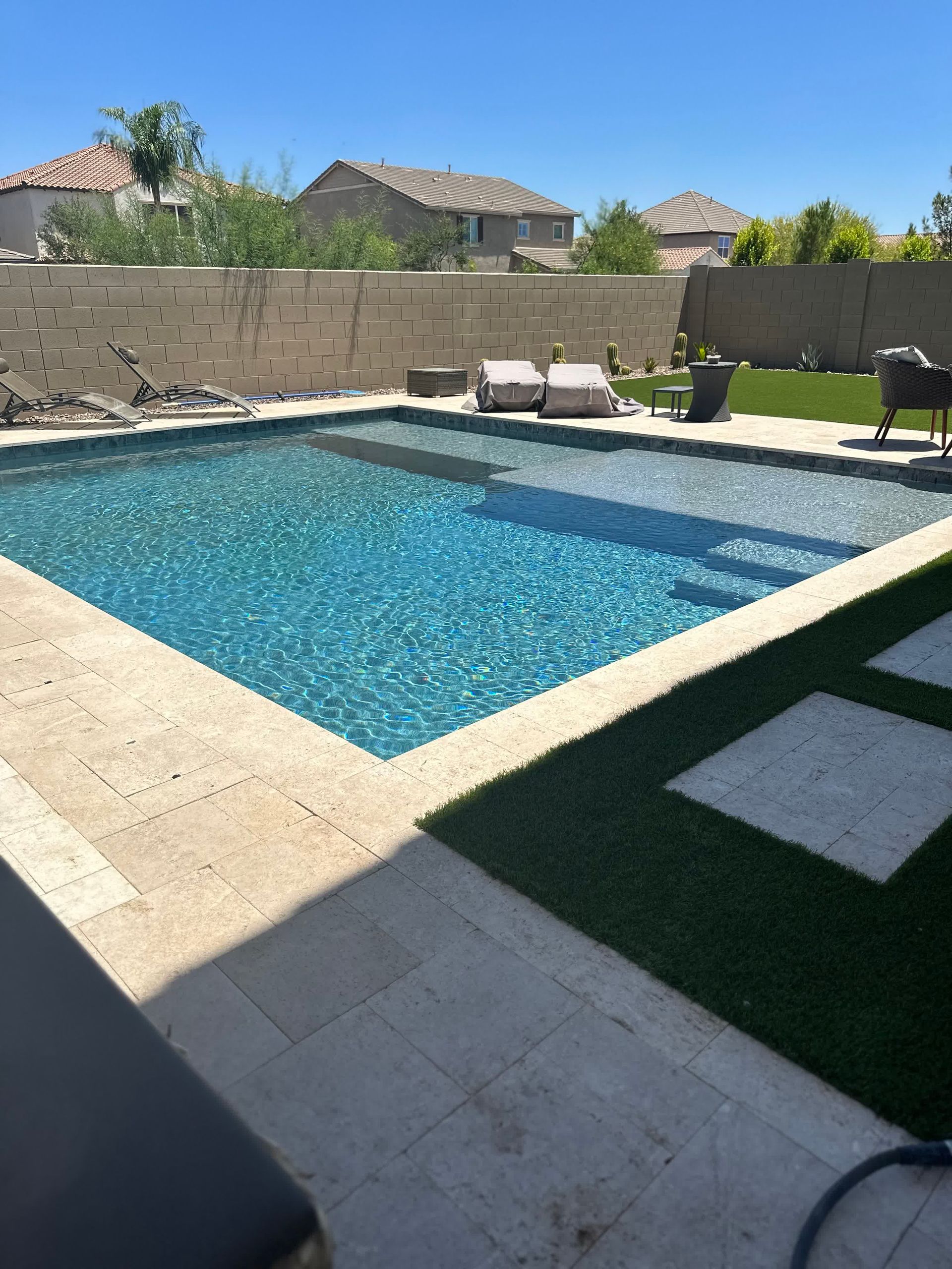 A large swimming pool in the backyard of a house