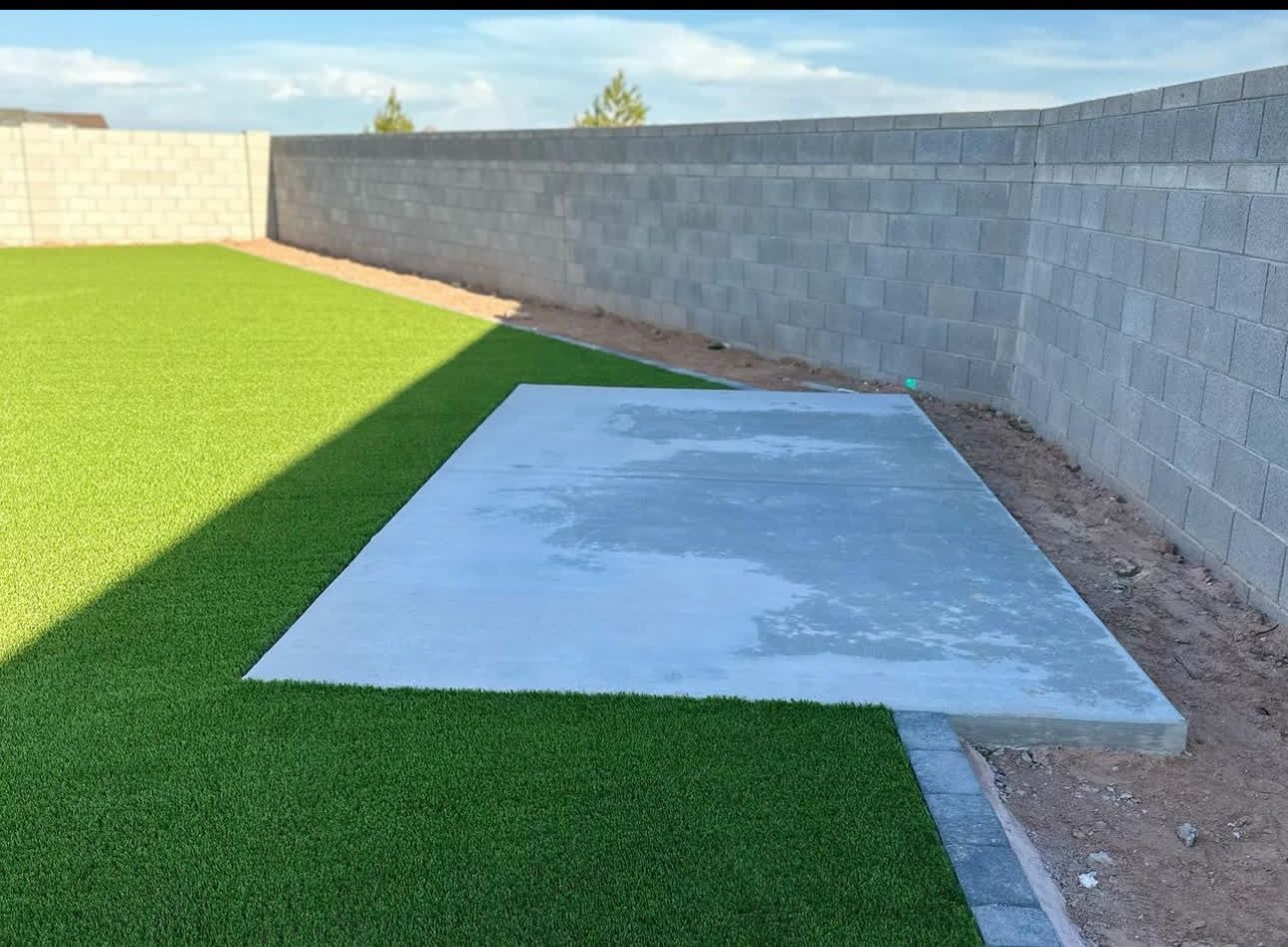 A concrete slab is sitting on top of a lush green lawn.