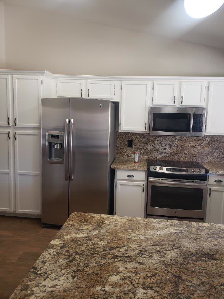 A kitchen with stainless steel appliances and granite counter tops