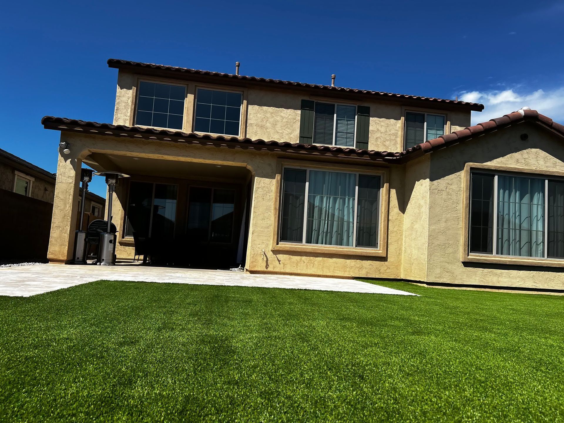 A large house with a lush green lawn in front of it.