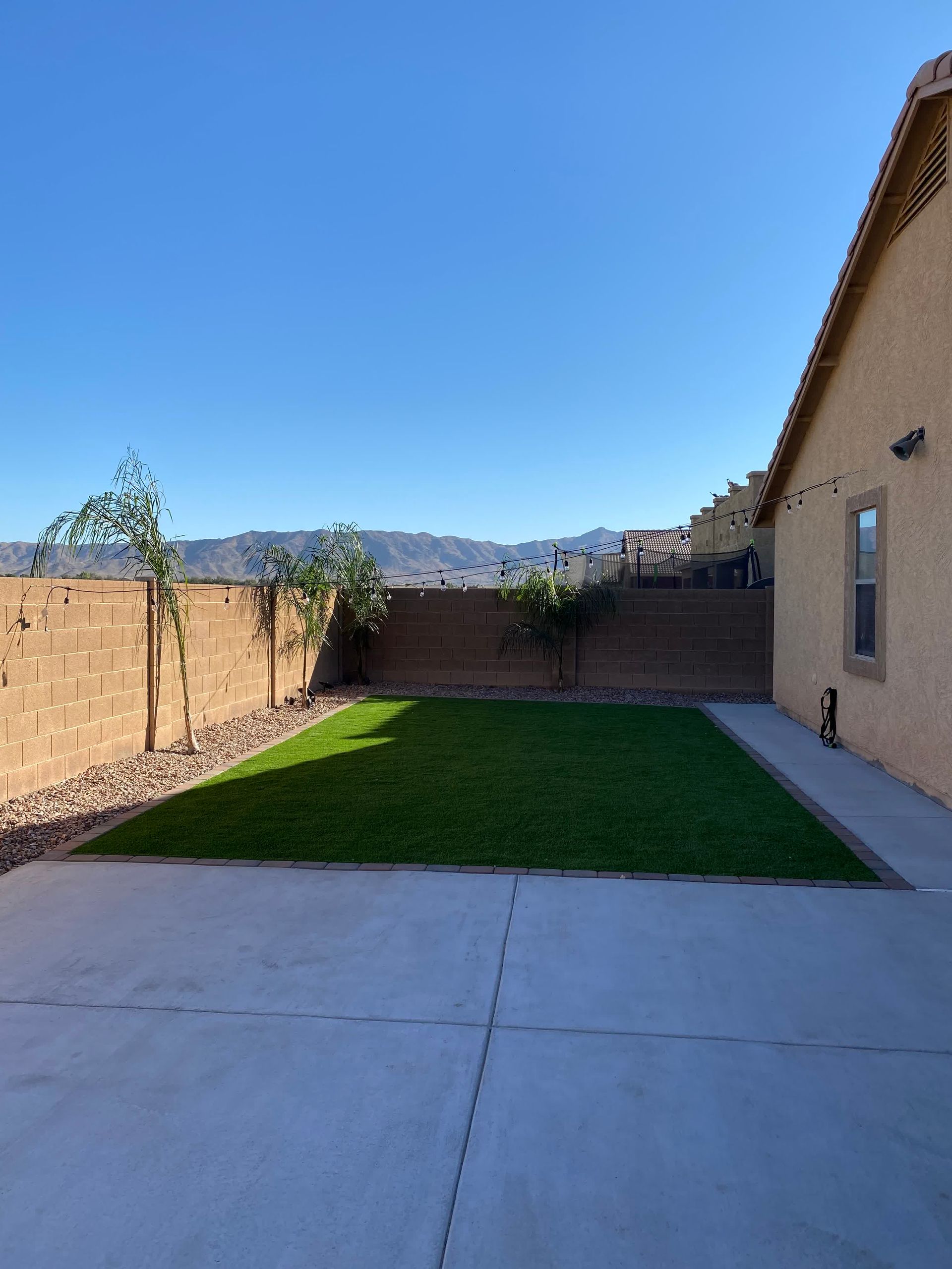 A house with a large lawn in front of it