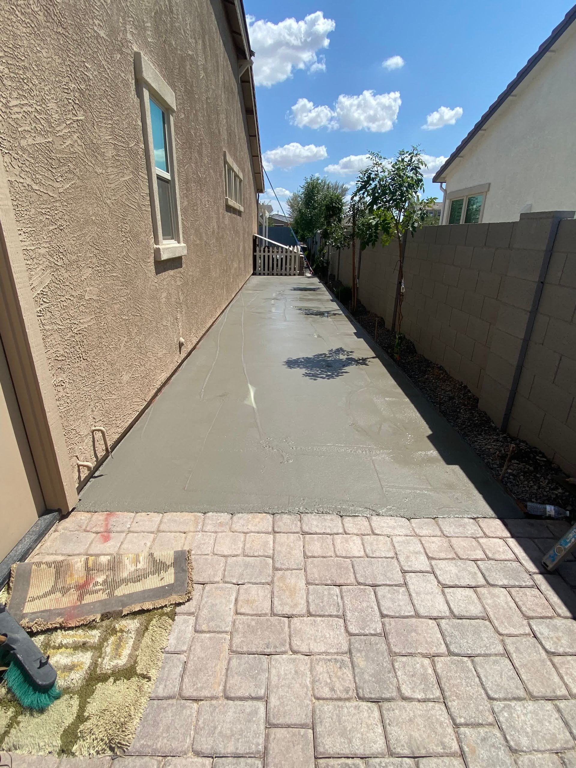 A brick walkway is being built in front of a house.
