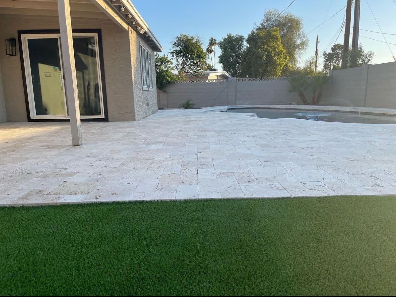 A house with a patio and a pool in the backyard