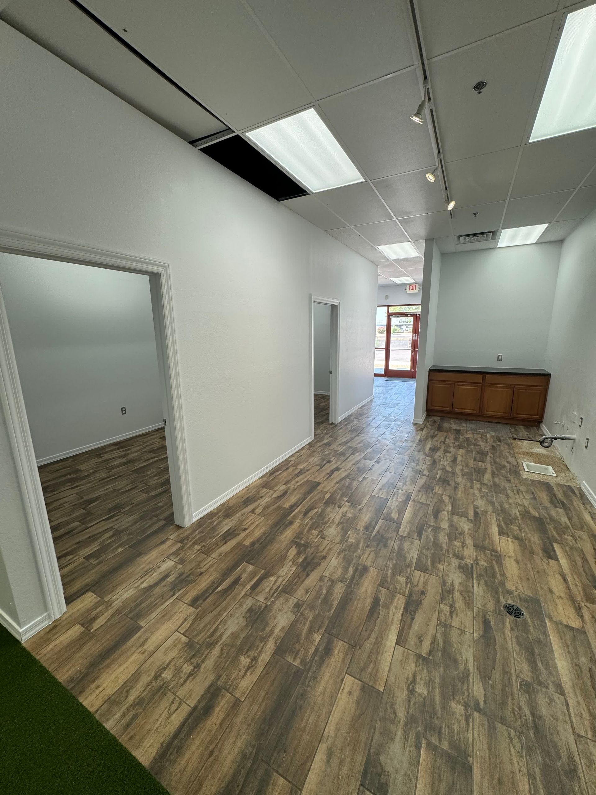 An empty room with wooden floors and white walls.