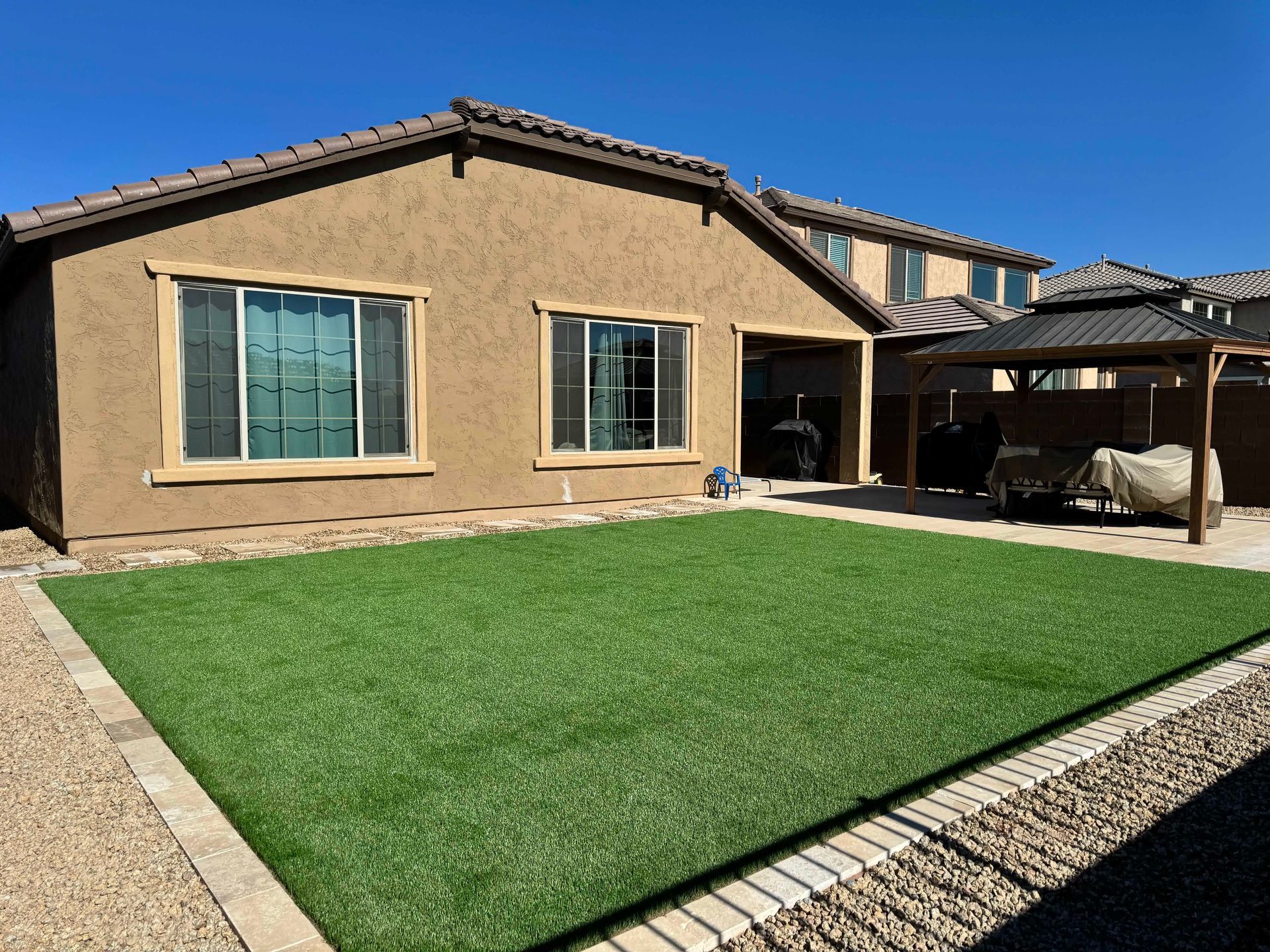 A house with a large lawn in front of it.