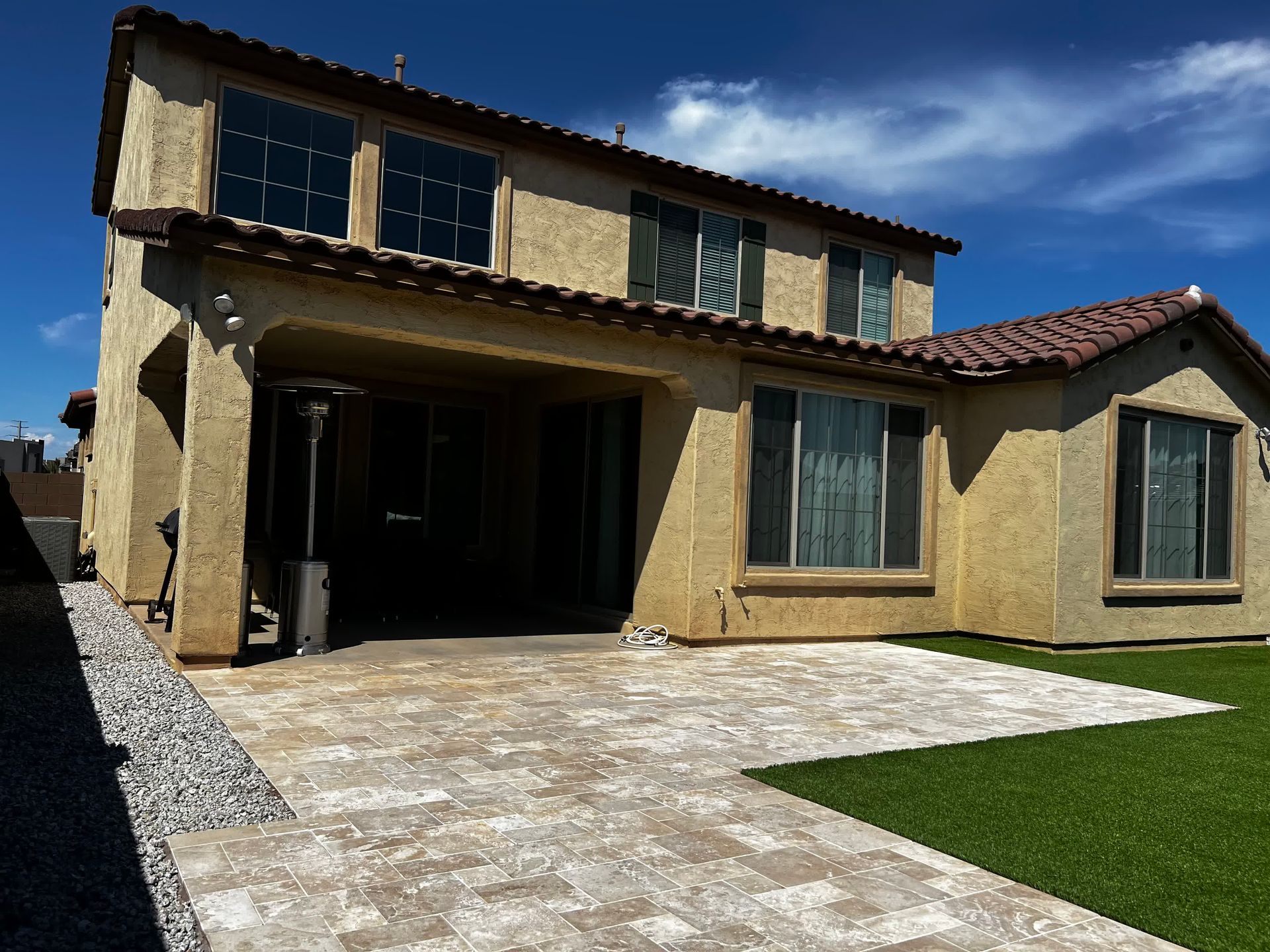 A large house with a lot of windows and a patio