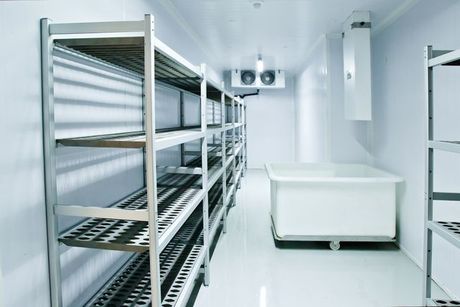 A room with shelves and a table in it
