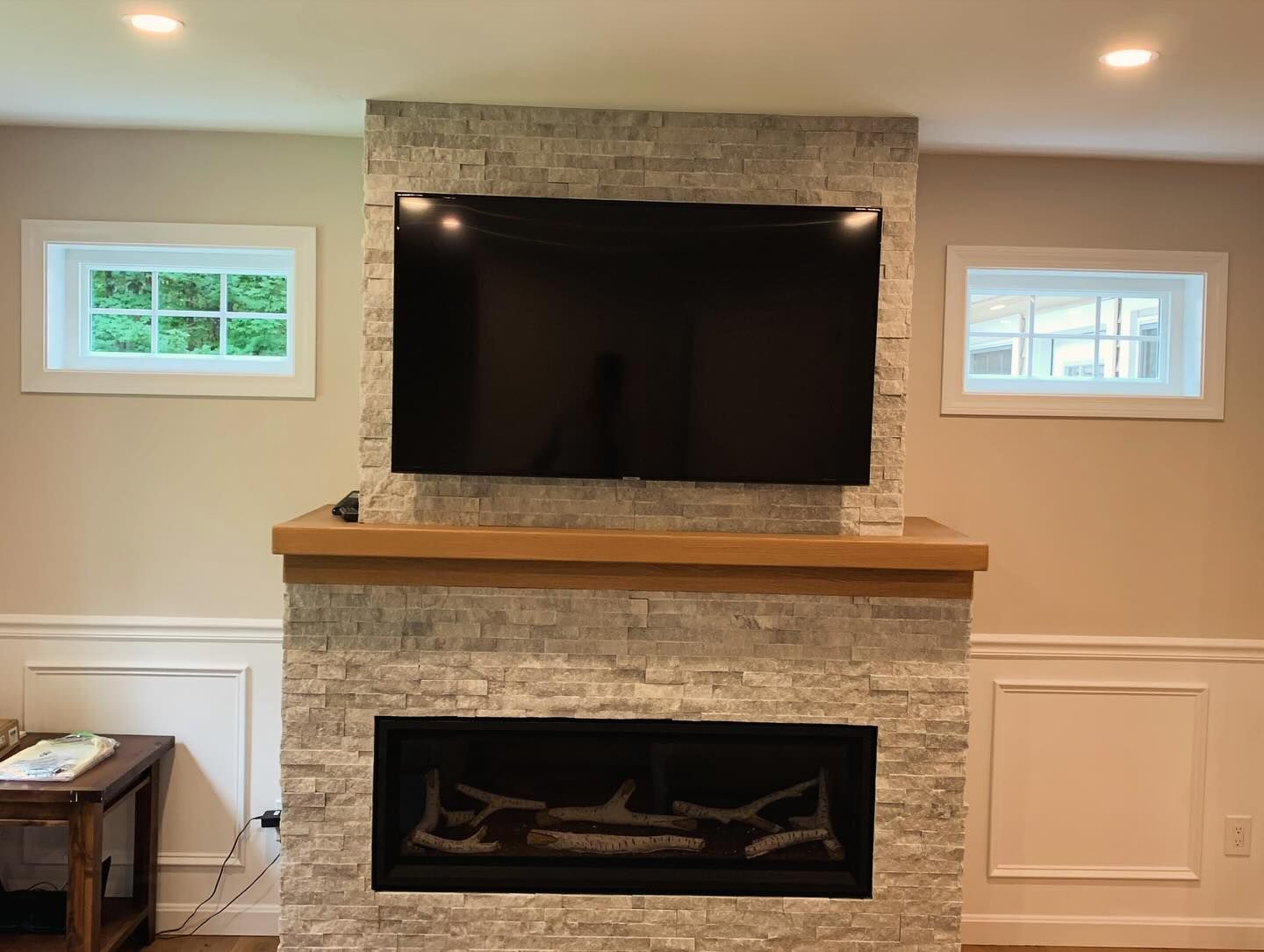 A fireplace with a flat screen tv mounted above it