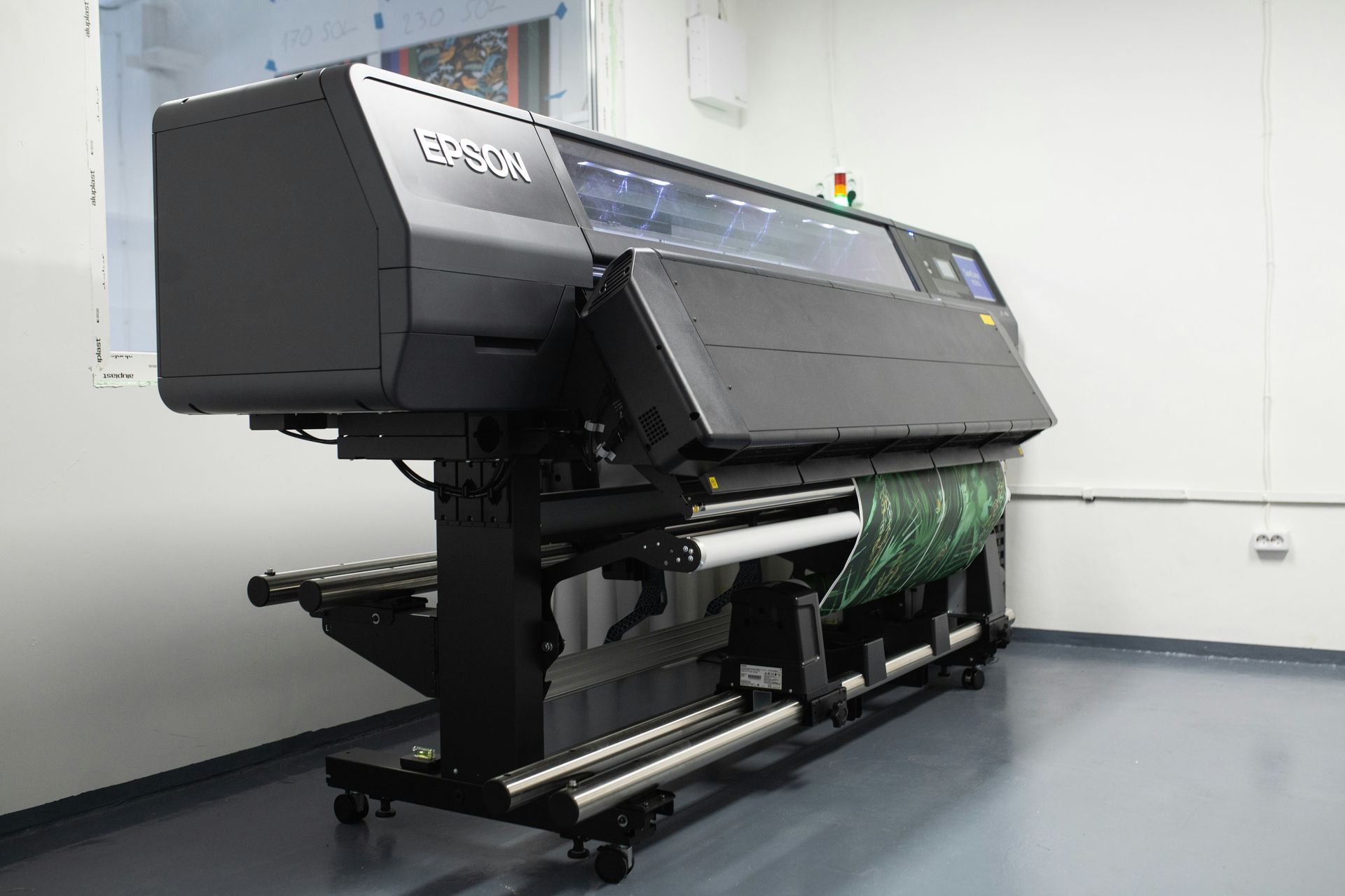 Epson SureColor large-format printer displaying vivid sample prints for banners and signage