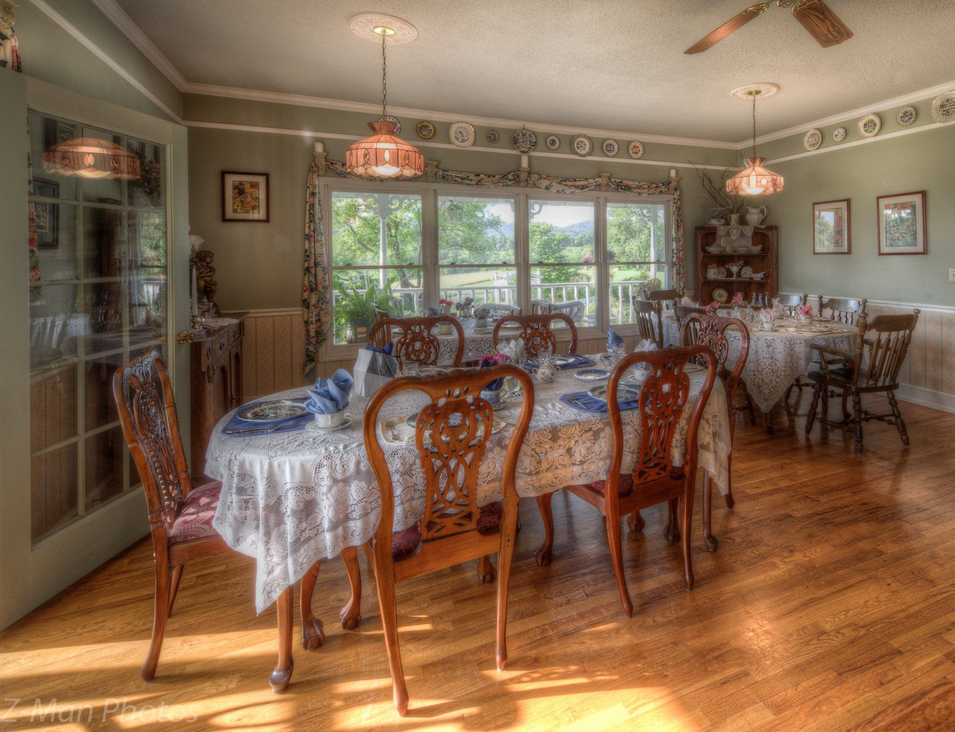 A dining room with a long table and chairs