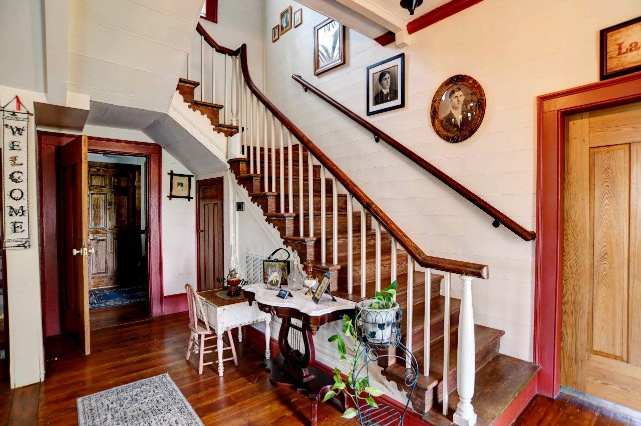 A staircase in a house with a welcome sign on the wall