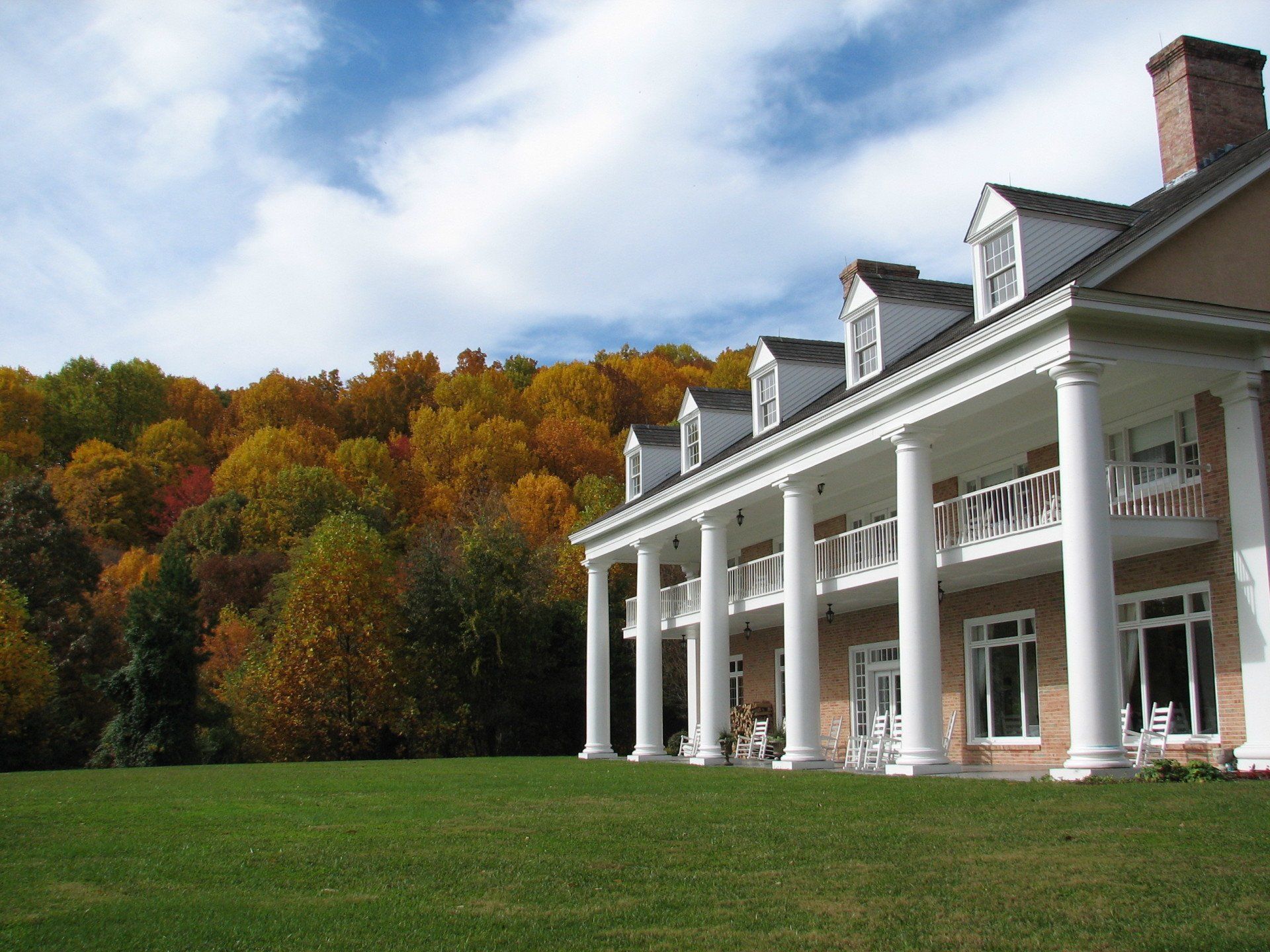 A large house with a lush green field in front of it